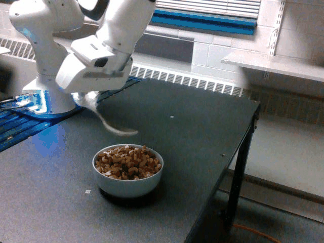 A video of a robot arm scooping up nuts