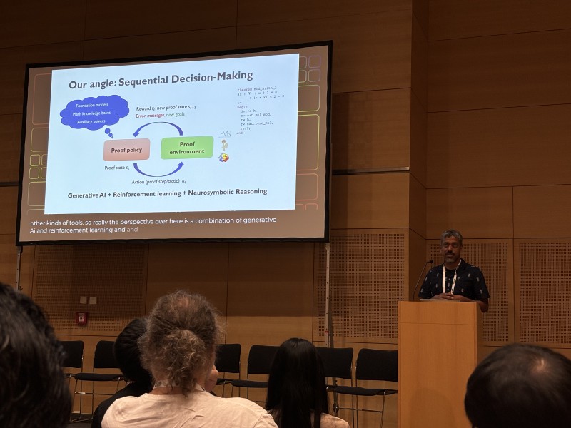 Swarat Chaudhuri presenting a slide titled “Our angle: Sequential Decision-Making”