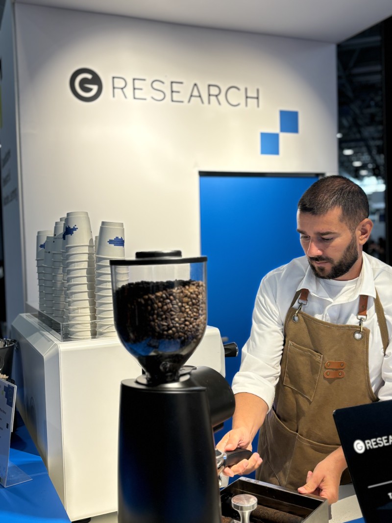 A barista making coffee at G-Research’s stand