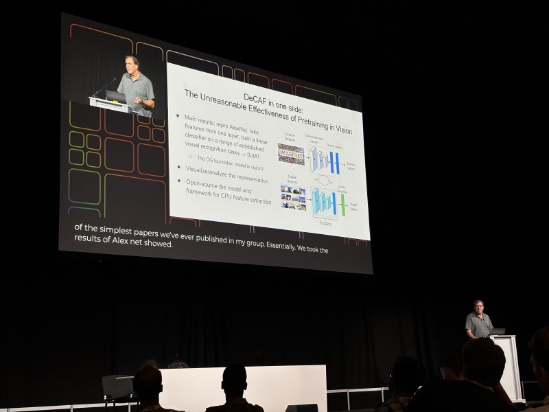 Trevor Darrell presenting a slide titled ‘How to Improve the Model with Only Text Feedback’ on stage at ICML 2024