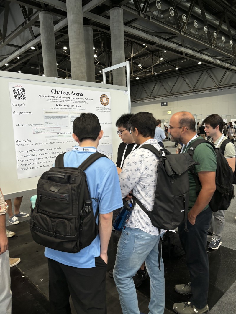 Conference attendees looking at the ‘Chatbot Arena’ Poster