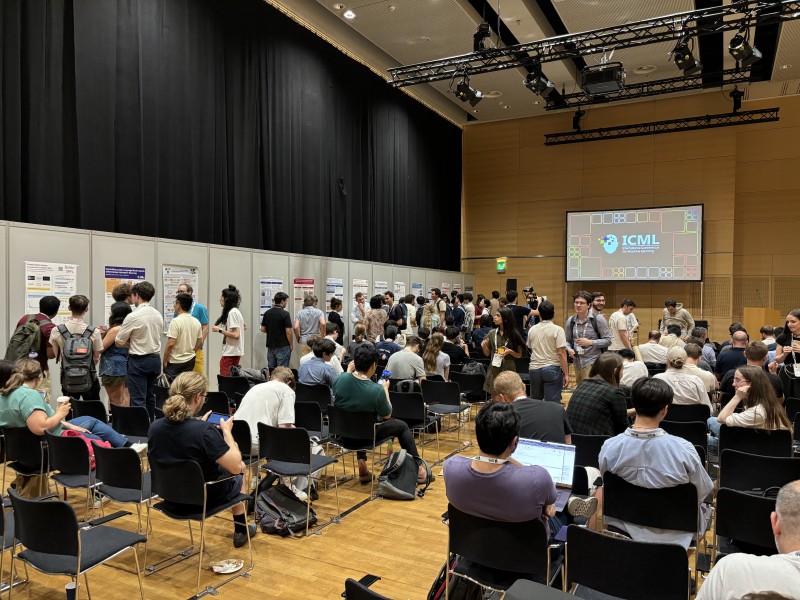 A group of people look at workshop posters