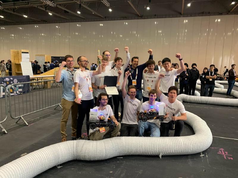 The Forza ETH team members, holding their car and trophy