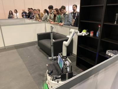 A robot about to grab a can of tomato soup from a shelf